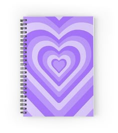 a spiral notebook with a purple heart on the front and bottom, surrounded by smaller hearts