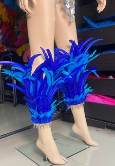 mannequin's legs with blue feathers on display