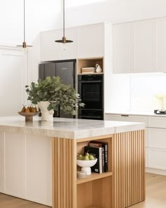 a kitchen with white cabinets and an island