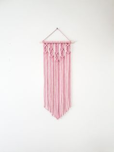 a pink wall hanging on a white wall