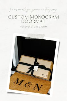 the monogrammed doormat is on display in front of an open box with a bow