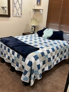 a blue and white checkered bedspread on a bed