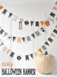 an easy halloween banner made out of paper and black and white striped pennants, with the words easy halloween banner on it