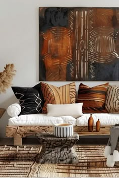 a living room filled with lots of furniture and pillows on top of a rug next to a painting