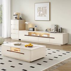 a modern living room with white furniture and black and white rugs on the floor