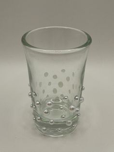 a clear glass with white dots on it