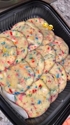 there are many cookies that have sprinkles on them in the pan and ready to be eaten