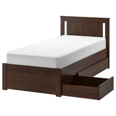 a bed with two drawers underneath it and a white sheet on the bottom half of the bed