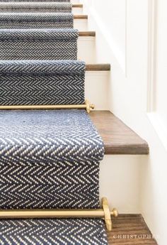 some blue and white carpeted stairs with wooden handrails in a home setting