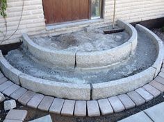 a stone steps leading up to a wooden door