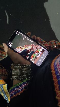 a person holding up a cell phone with an image on the screen