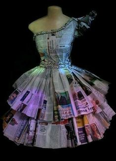 a dress made out of newspapers sitting on top of a mannequin