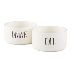 two white bowls with the words drink and eat on them