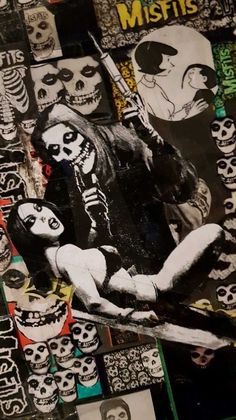 a collage of skulls and stickers on a wall