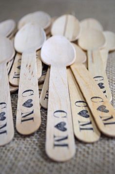 wooden spoons that say i love you and are lined up on a tablecloth