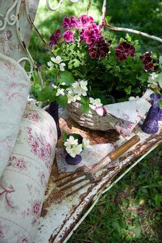 an old chair with some flowers in it