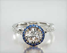 an engagement ring with blue and white diamonds