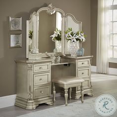 a white vanity with mirror and stool in a room