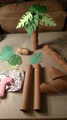 a table topped with lots of different types of paper cut outs and palm tree decorations