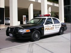 a police car parked in front of a building