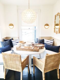 a dining room table with chairs around it and a tray on the table in front of them