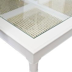 a white coffee table with glass top