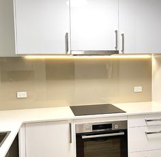 a kitchen with white cabinets and an oven