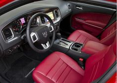 the interior of a car with red leather seats