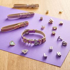 several different types of jewelry sitting on top of a purple mat