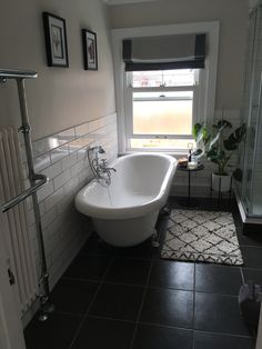 a white bath tub sitting next to a window