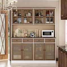 a kitchen with wooden cabinets and white microwave on the top shelf next to an open door