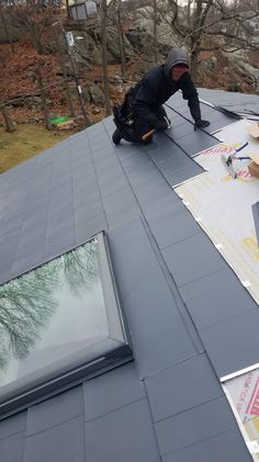 a man working on the roof of a house