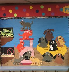 a bulletin board with dogs and cats on it in front of a classroom wall display