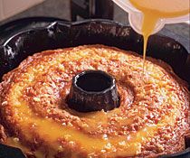 a cake in a pan with syrup being poured on top