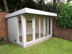 a garden room with sliding glass doors on the outside