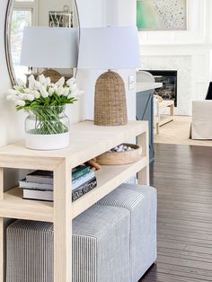 a living room filled with furniture and a large mirror above the coffee table in front of it