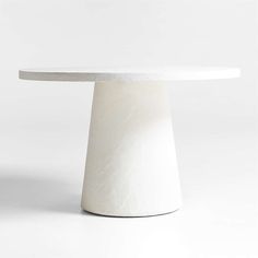 a white table with a circular top on a plain surface in the shape of a cone