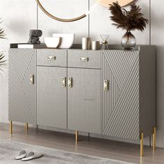 a sideboard with two doors and gold handles in a modern living room, next to a potted plant