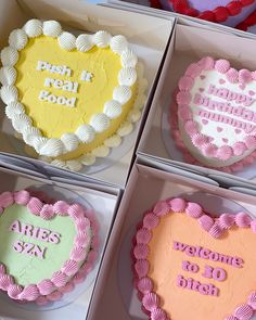 four heart shaped cakes in boxes with words on them