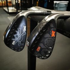 two irons with skulls and spider web on them