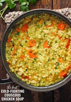 a large pot filled with soup on top of a wooden table