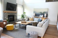 a living room filled with furniture and a flat screen tv mounted on the wall above a fire place