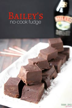 chocolate fudge on a white plate with chopsticks and bottle in the background