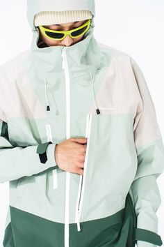 Discover the fusion of cutting-edge design and practicality with the Asymmetric Water-Proof Windbreaker. Crafted to provide exceptional waterproof capabilities, this jacket is a staple for the style-conscious adventurer. The futuristic paneled design lends a modern edge, while the dual zippers under the arms ensure ample breathability during vigorous activities. Attention to detail is evident in the "right as rain" embroidered text on the cuffs, adding a unique character to this functional piece Utility Clothing, Technical Apparel, Embroidered Text, Fresh Color Palette, Fresh Color, Outdoor Fashion, Outdoor Jacket, Jacket Design, Edge Design