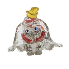 a glass elephant figurine with a gold hat on its head