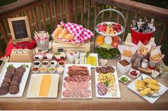 a table filled with lots of food on top of a wooden table covered in plates and bowls