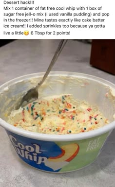 a bowl of ice cream with sprinkles and a spoon sticking out of it