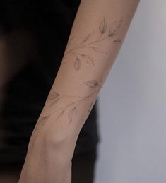 a woman's arm with a flower tattoo on it