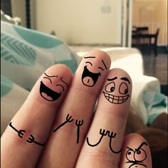 someone has drawn faces on their fingers