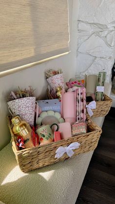 a basket filled with lots of different types of items on top of a floor next to a window